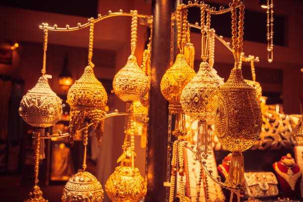 Selection of gold colored decorative items for sale in a souk